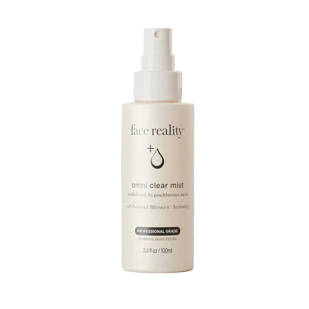 A 3.4 fl oz / 100 ml bottle of face reality Omni Clear Mist on a solid, warm beige background.